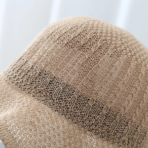 Detailed macro view of khaki knitted sun hat texture with breathable hollow-out weave
