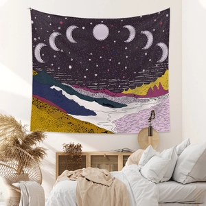 Bohemian tapestry featuring starry night moon phases over colorful mountain landscape