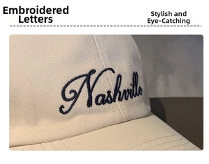 Close-up of Nashville letter embroidery on the off-white twill cotton baseball cap
