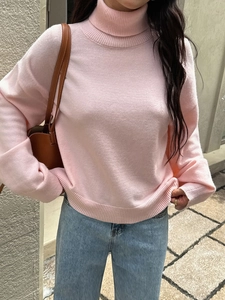 Maglione da donna in maglia rosa a collo alto con polsini a coste e vestibilità ampia