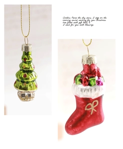 Detail of hand-painted glass Christmas ornaments in green tree and red stocking shapes