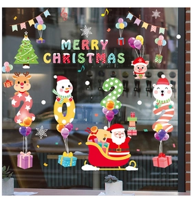 Detail of Christmas window decals featuring Santa, reindeer and snowman on glass shop front