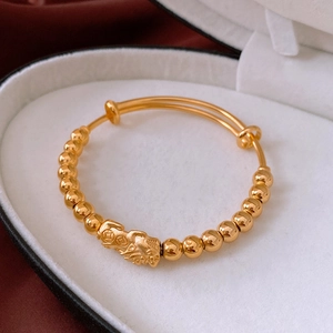 Macro shot of 18k gold plated Pixiu bracelet with jade beads in a white jewelry gift box