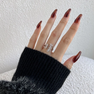 Close-up of S925 silver leaf ring featuring marquise zircon on finger with soft lighting