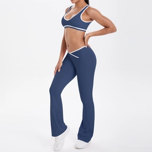 Navy blue yoga set featuring a white-trimmed sports bra and high-waisted flared leggings