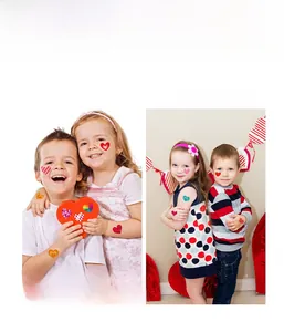 Macro view of colorful heart-shaped temporary tattoos applied on children cheeks and arms