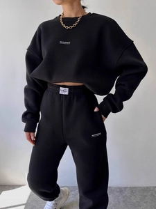 Women's black two-piece lounge set with long sleeve sweatshirt and high-waist joggers