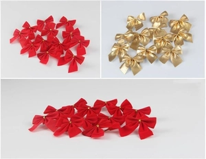 Detailed view of red flocked and metallic gold mini Christmas decorative bows in bulk