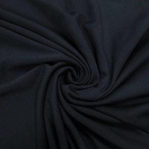 Close-up of black elastic polyester fabric texture on slim fit backless dress
