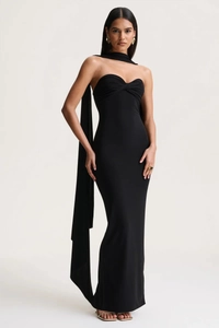 Detail of black strapless maxi dress with front twist knot and long neck streamers