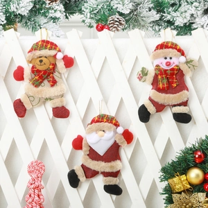 Three Christmas plush ornaments featuring Santa Snowman and Bear on rustic wood fence