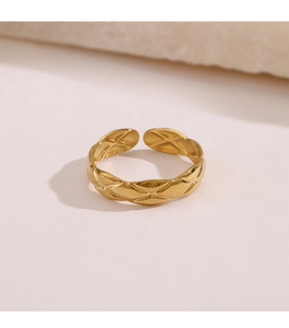 Detailed view of adjustable gold-plated geometric ring with classic quilted pattern