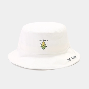 Close-up of white canvas bucket hat featuring corn embroidery and detailed stitching