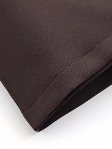 Close-up of dark brown fabric texture and neat double stitching on retro blazer suit