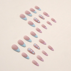 Matte almond press-on nails with French blue tips and delicate floral designs