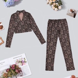 Flat lay of pink two-piece set with V-neck crop top and matching patterned pants