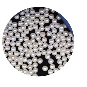 Glossy white 4mm freshwater pearl beads for DIY jewelry making on black background