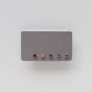 Detail view of five multi-colored birthstone stud earrings with four-prong silver settings