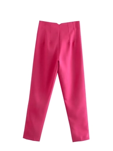 Detail view of high-waisted rose red trousers featuring decorative vertical waist stitching
