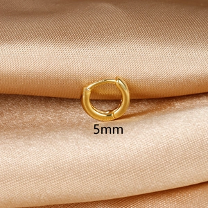 Close-up of 5mm gold mini hoop earring on champagne satin background for helix piercing