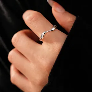 Minimalist silver irregular wavy ring in 18k gold plating shown on model's hand