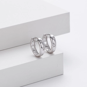 Detail of 925 sterling silver hoop earrings with hollow stars and micro-pave crystals