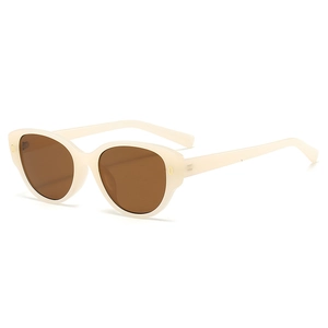 Retro cat-eye sunglasses with cream frames, brown lenses and gold oval accents