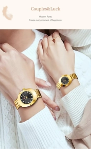 Close-up of golden couple watches with diamond accents on wrists for a modern style