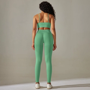 Close-up of seamless mint green knitted fabric and high-waisted fitness leggings