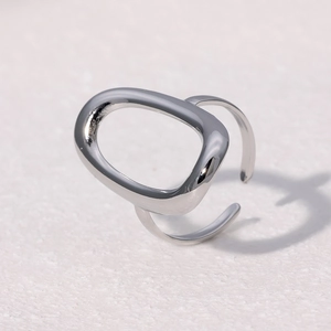 Detailed view of an adjustable silver hollow oval ring with polished mirror finish