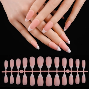 Macro detail of almond French tip press-on nails set in nude pink and white