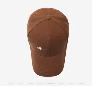 Top view of dark brown baseball cap featuring white letter embroidery and a curved brim