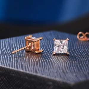 Macro shot of princess cut square zircon earrings with four-prong rose gold setting