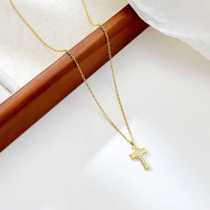 Elegant gold-plated cross pendant necklace with sparkling crystals on a minimalist chain