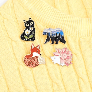 Japanese style animal enamel pins set with cat, bear and fox on yellow sweater