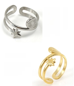 Detail view of adjustable crossover rings with star and sun motifs in gold and silver