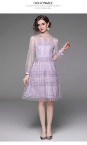Detail of purple lace mesh dress featuring intricate 3D floral embroidery and sheer sleeves