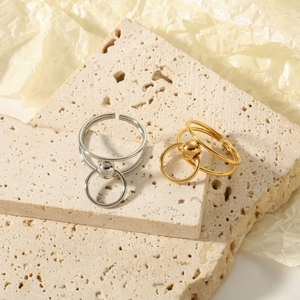 French vintage wheat-style twisted rings in gold and silver on travertine stone