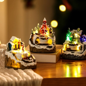 Detailed view of resin Christmas village set with warm LED lights and Santa Claus