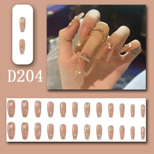 Detail of nude pink press-on nails with golden bee, pearls and 24 pieces full set