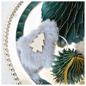 Close-up of plush grey star and dark green paper honeycomb Christmas tree decorations