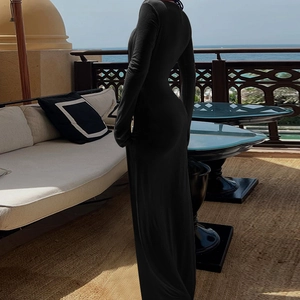 Elegant black long sleeve V-neck bodycon maxi dress shown on a scenic outdoor terrace