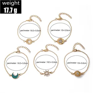 Size guide for a 5-piece gold bracelet set featuring sun, moon, and coin charms