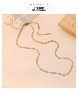 Close-up of elegant 18K gold snake chain necklace with lobster clasp and extender