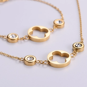 Macro shot of gold hollow clover necklace with sparkling cubic zirconia settings