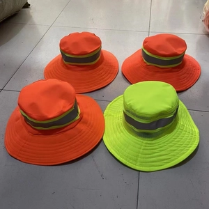 Detailed view of high-visibility safety sun hats in orange and neon green with reflective strips