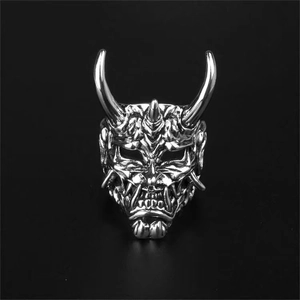 Detailed close-up of a silver Prajna mask ring with vintage punk aesthetic and horn details