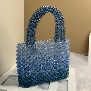 Detailed macro view of handmade gradient blue acrylic beaded tote bag with faceted beads