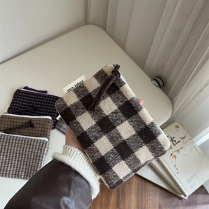 Close-up of a plaid wool fabric zipper pouch with simple wish brand tag detail