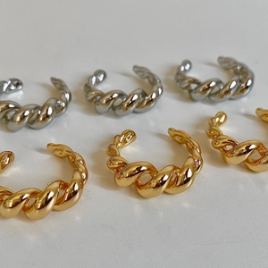 Minimalist twisted croissant style open rings in polished gold and silver finishes